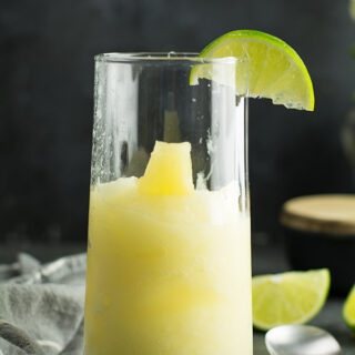 pineapple slush recipe-healthy, fruity summer drink with lemon wedges.